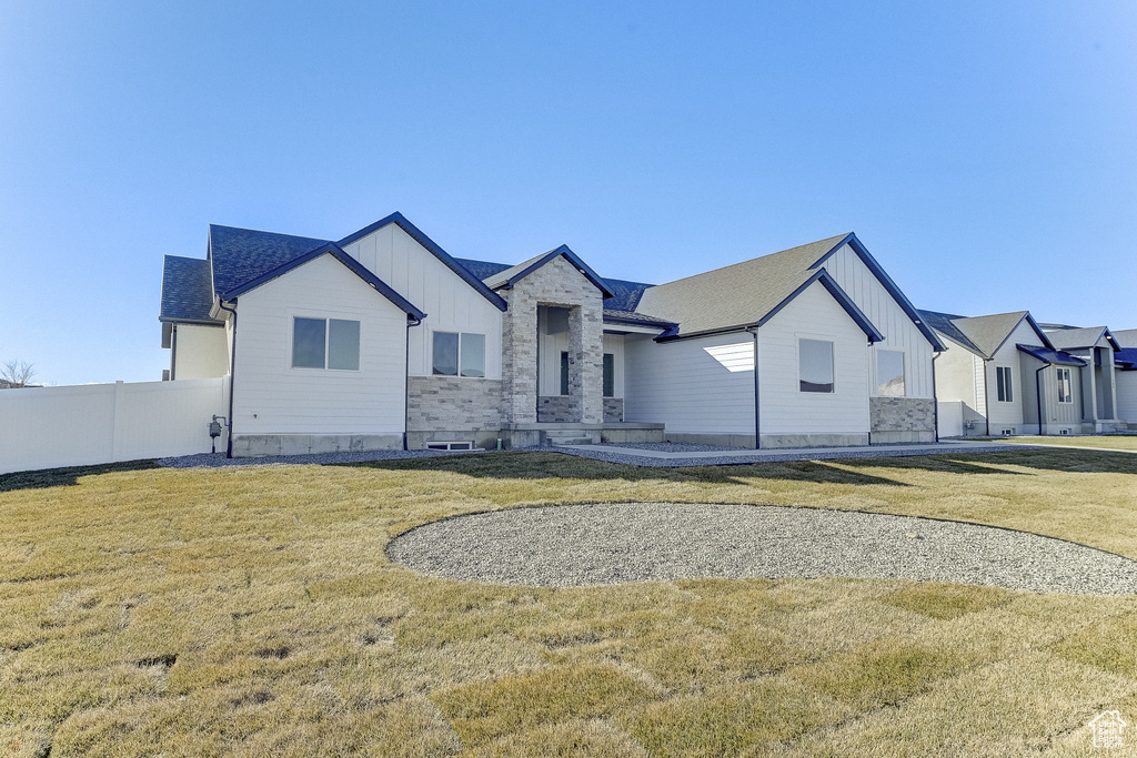 Modern farmhouse style home with a front lawn