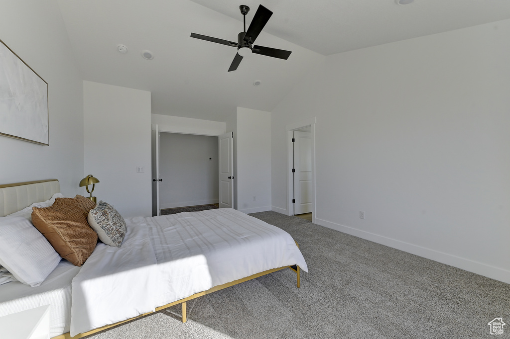 Bedroom with lofted ceiling, ceiling fan, and carpet floors