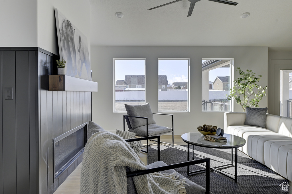 Living room featuring ceiling fan and light hardwood / wood-style floors