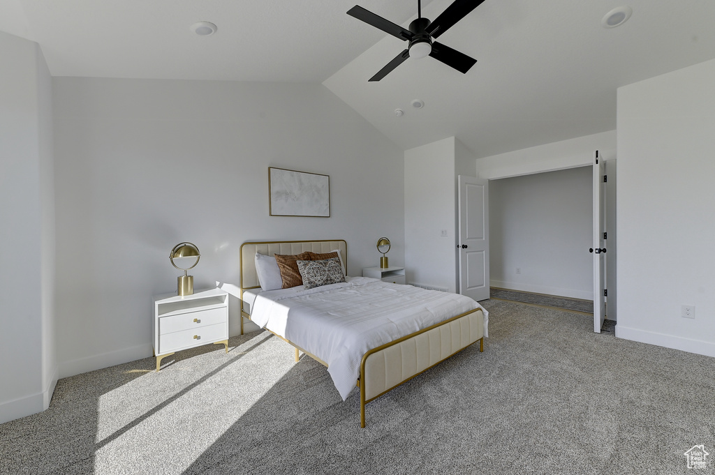 Bedroom featuring light carpet, vaulted ceiling, and ceiling fan