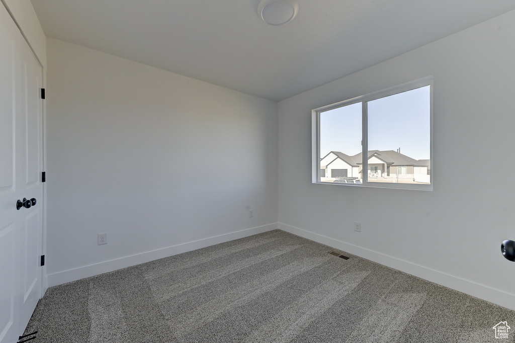 Spare room featuring carpet flooring