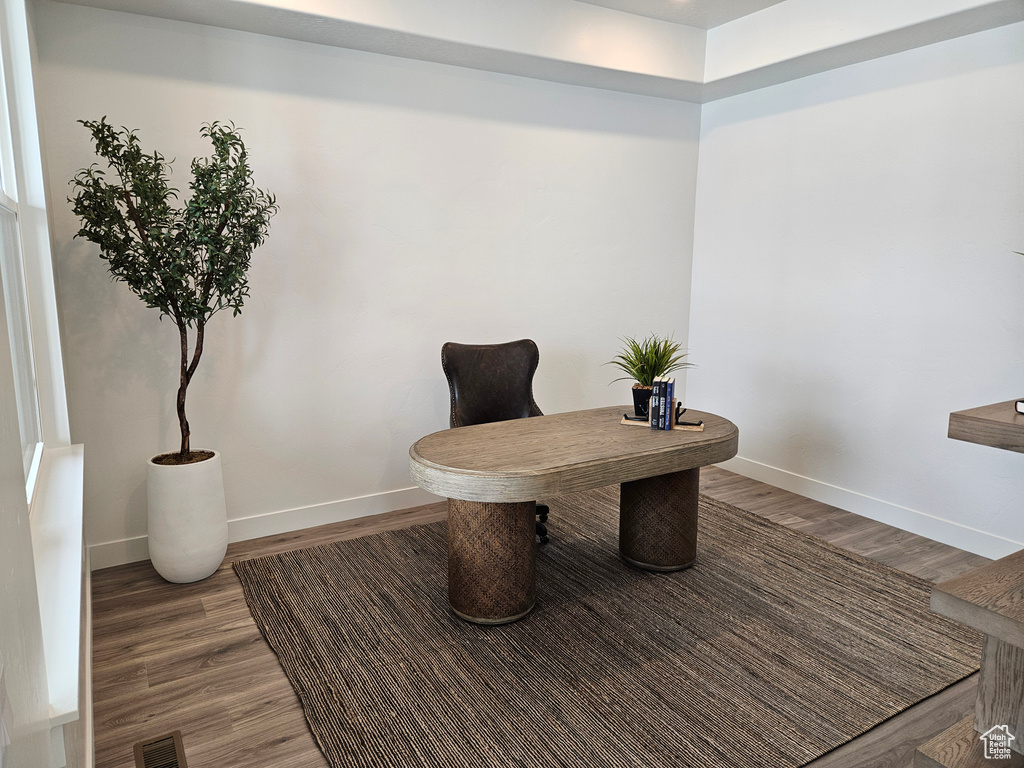 Office area featuring baseboards and wood finished floors