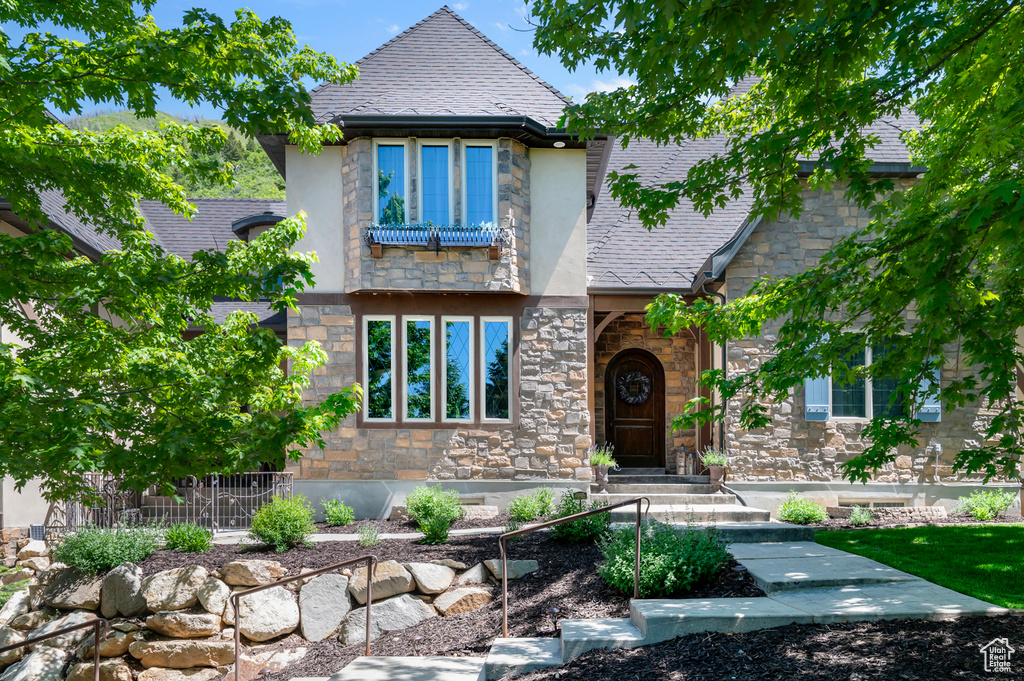 View of front of home with stone siding and stucco siding
