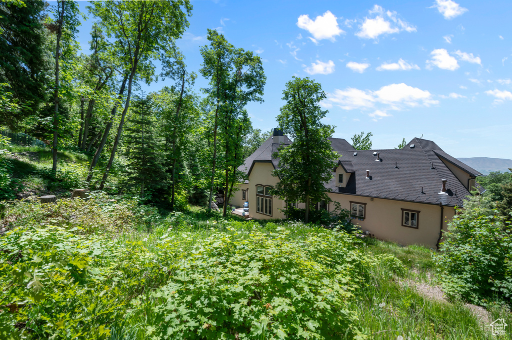 View of home\\\\\\\'s exterior featuring stucco siding and a chimney