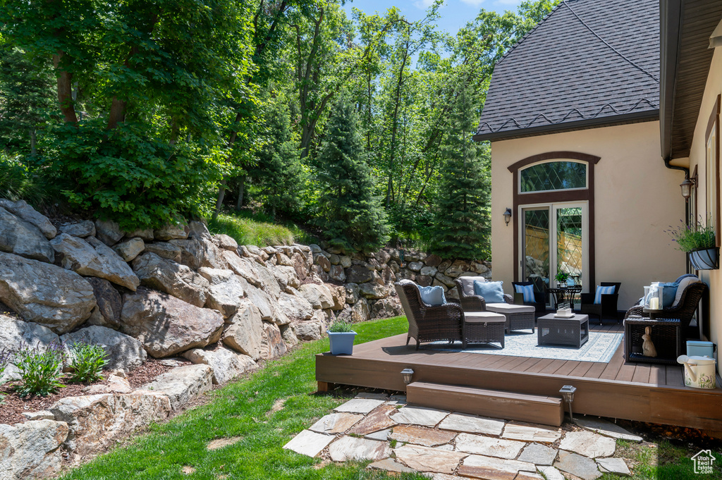 View of patio featuring outdoor lounge area and a wooden deck