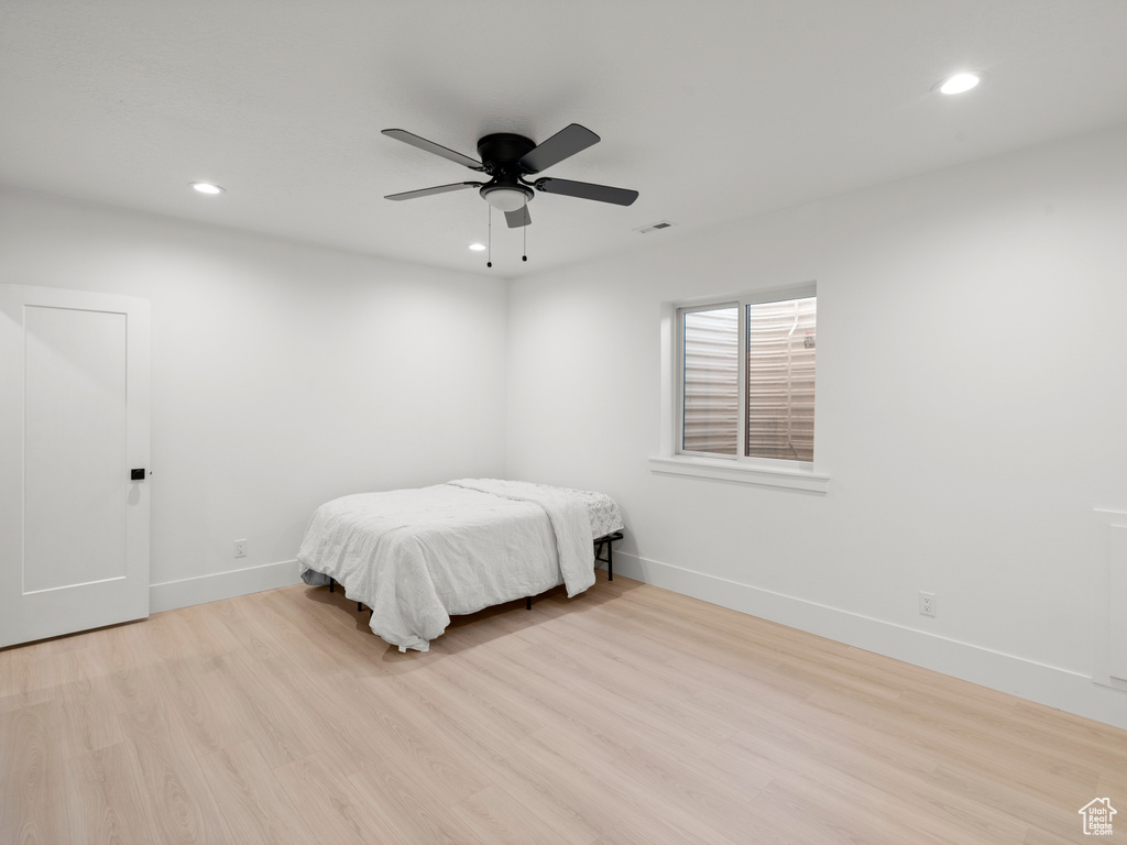 Bedroom featuring ceiling fan and light hardwood / wood-style flooring