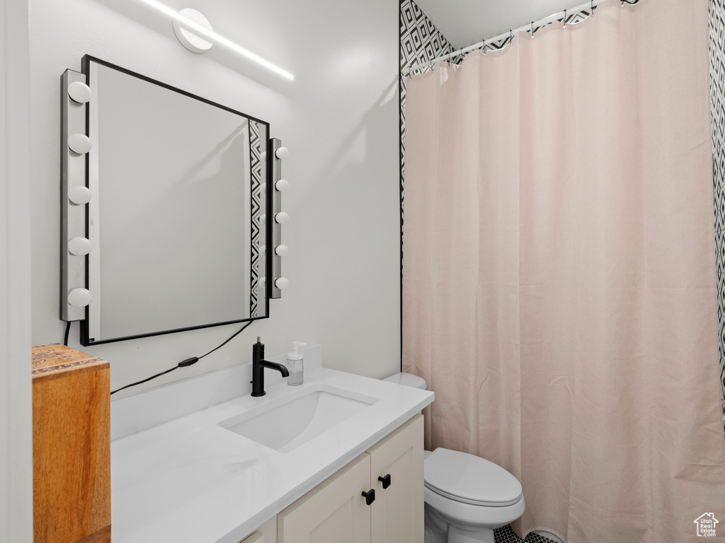 Bathroom featuring vanity and toilet