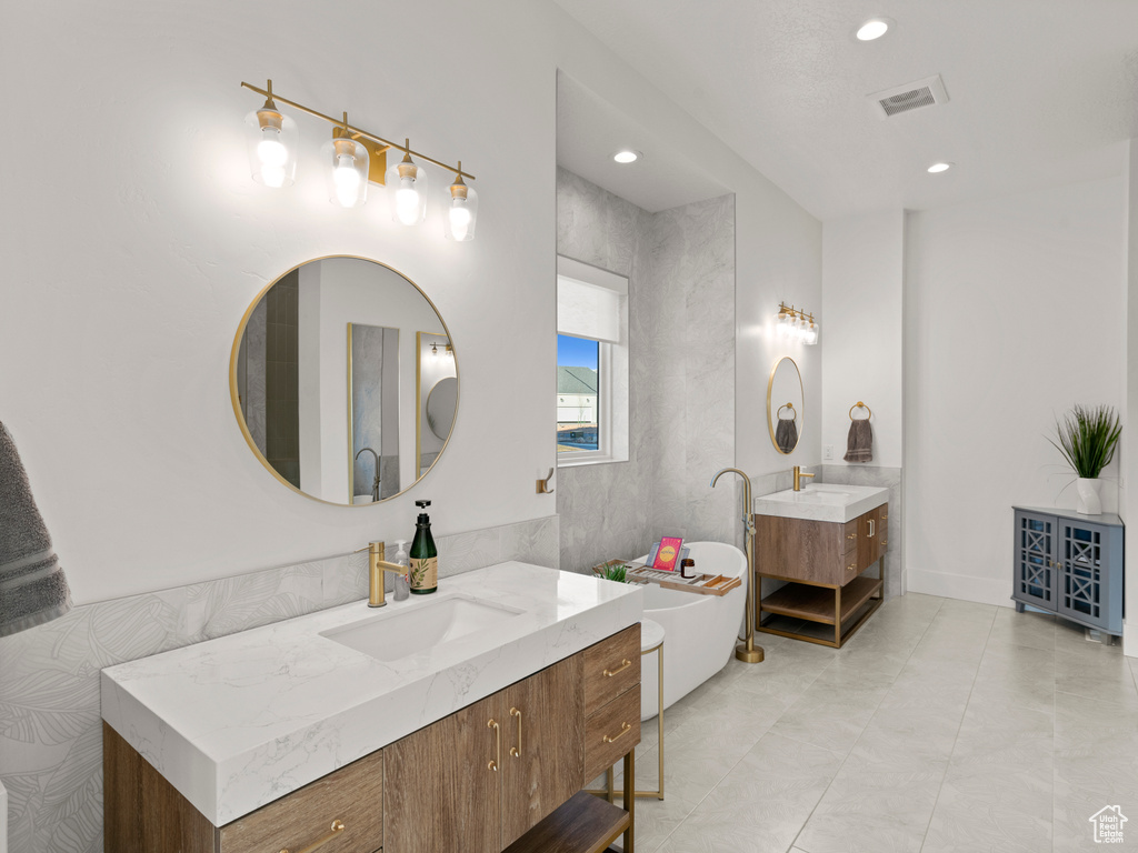 Bathroom with vanity and a bathing tub