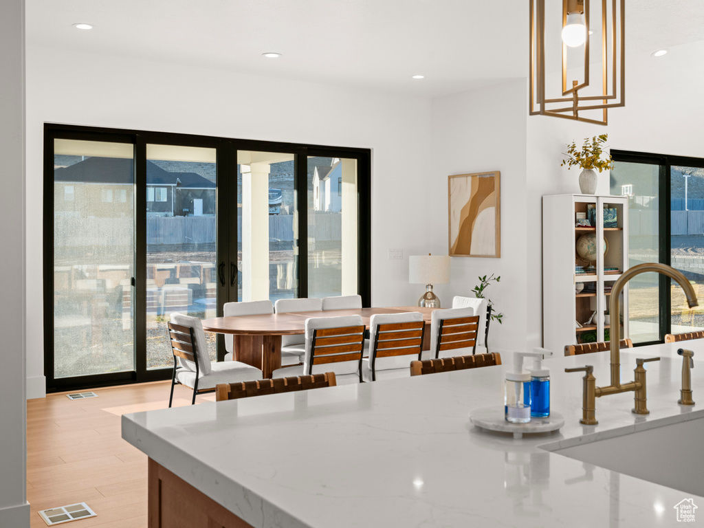 Dining area featuring sink and light hardwood / wood-style flooring