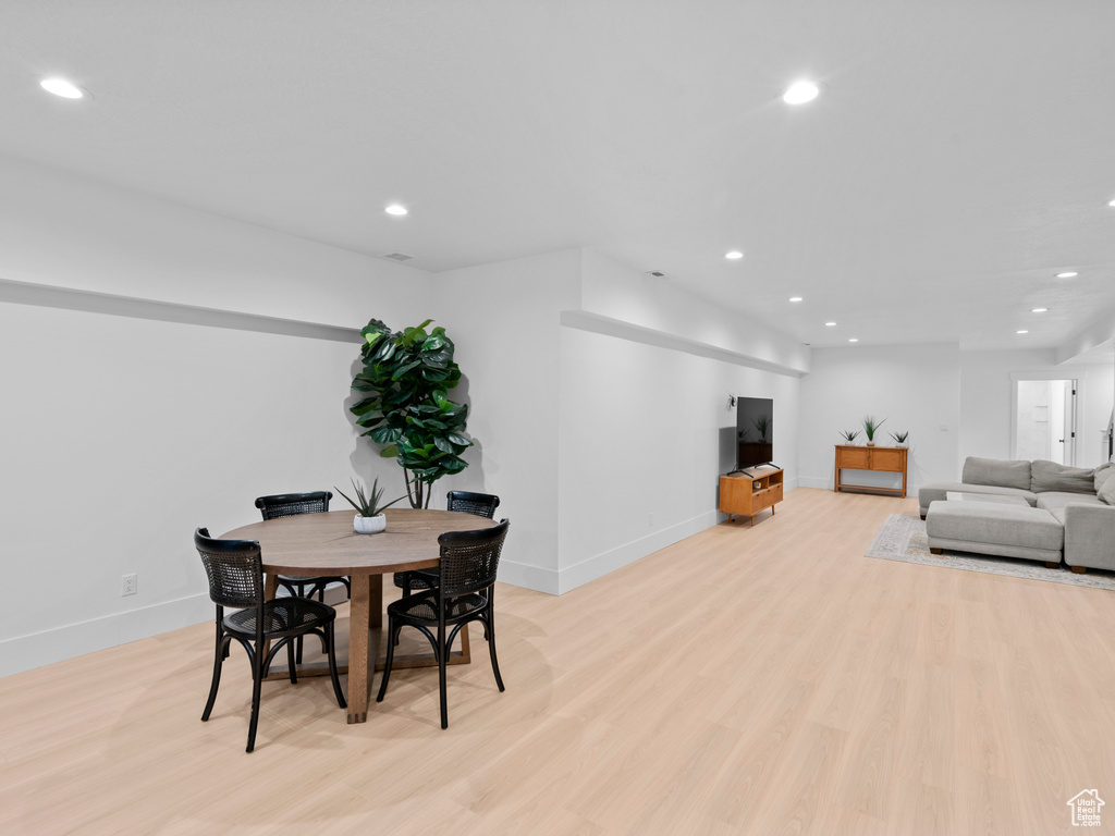 Dining space with light hardwood / wood-style flooring