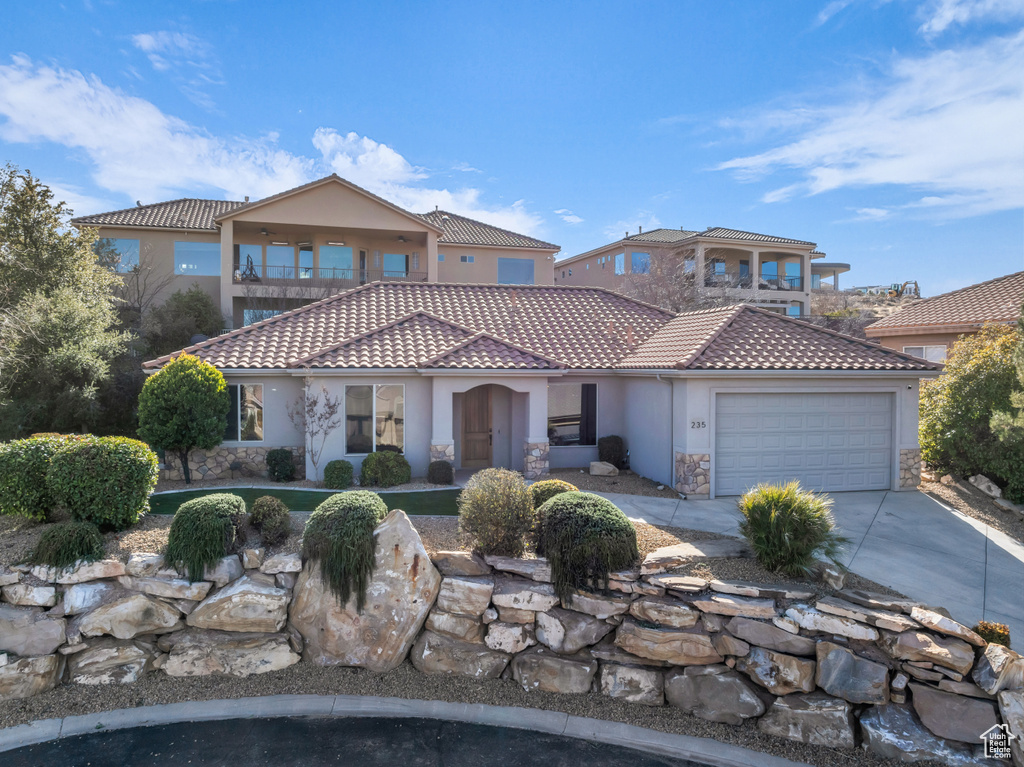 Mediterranean / spanish home with a balcony and a garage