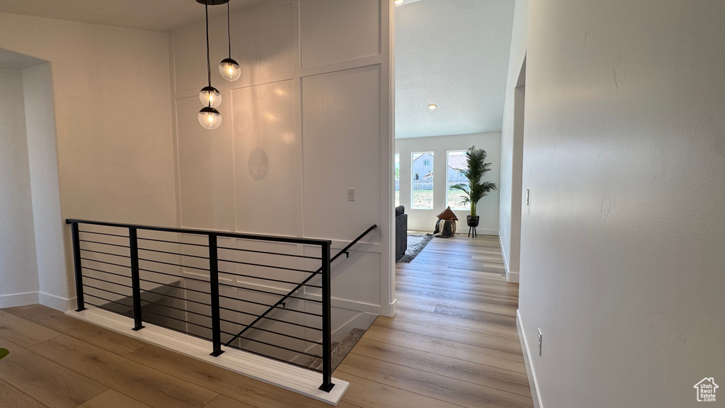 Staircase featuring wood finished floors and baseboards