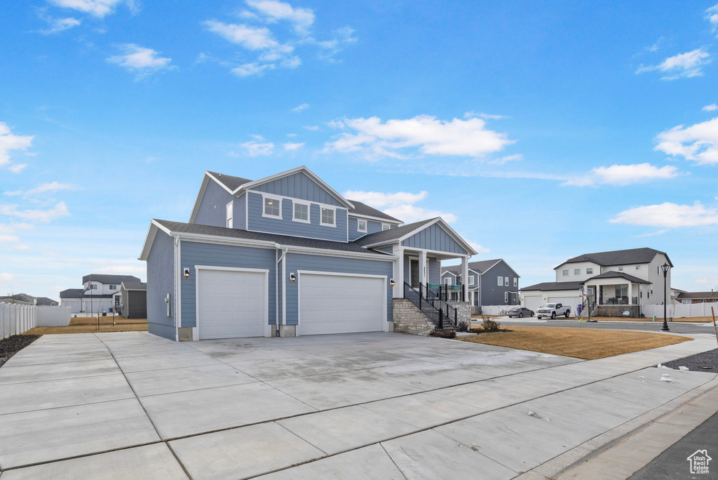 View of front of property with a garage and a porch