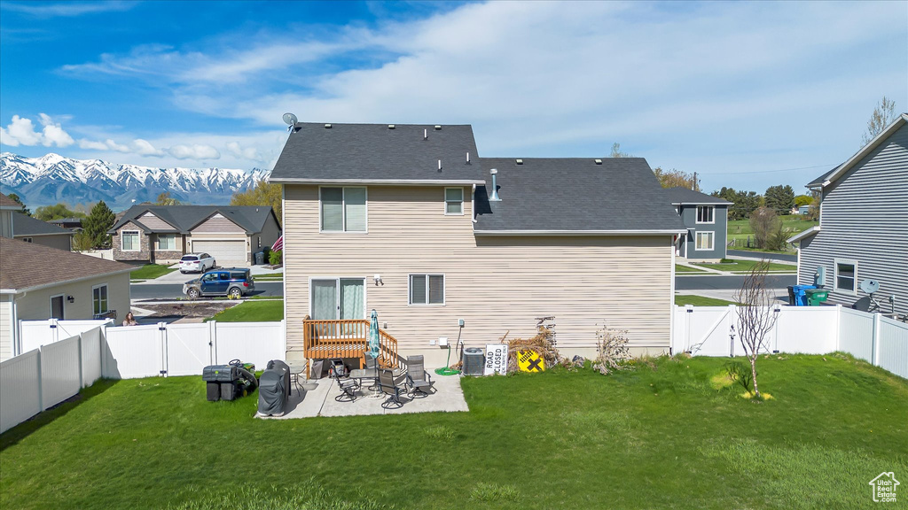 Rear view of house with a patio, a gate, and a fenced backyard