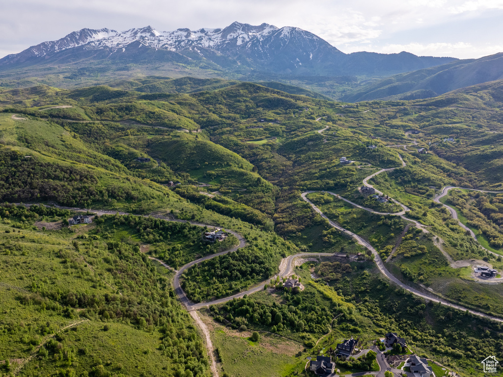 Aerial view of property's location featuring a mountainous background