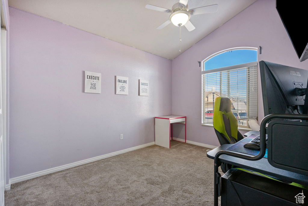 Office space featuring lofted ceiling, light colored carpet, and ceiling fan