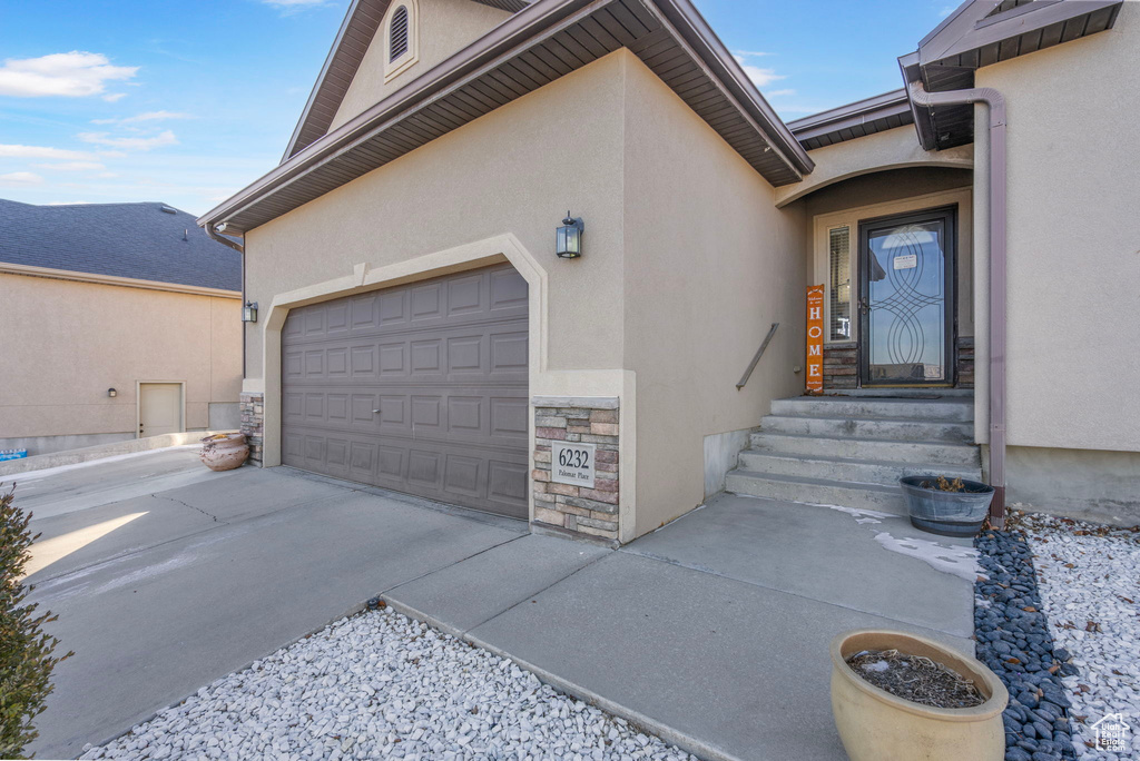 Entrance to property featuring a garage