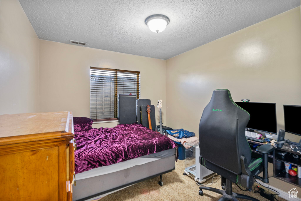 Bedroom featuring a textured ceiling and carpet flooring