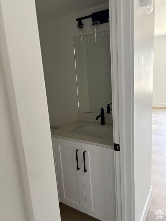 Bathroom featuring hardwood / wood-style flooring and vanity