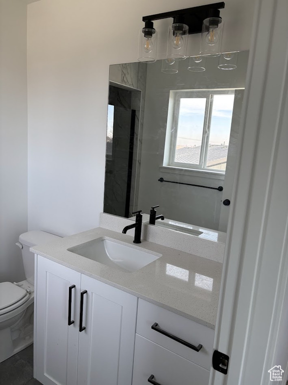 Bathroom featuring vanity and toilet