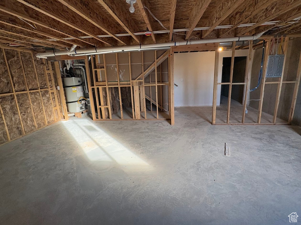 Basement featuring water heater and electric panel