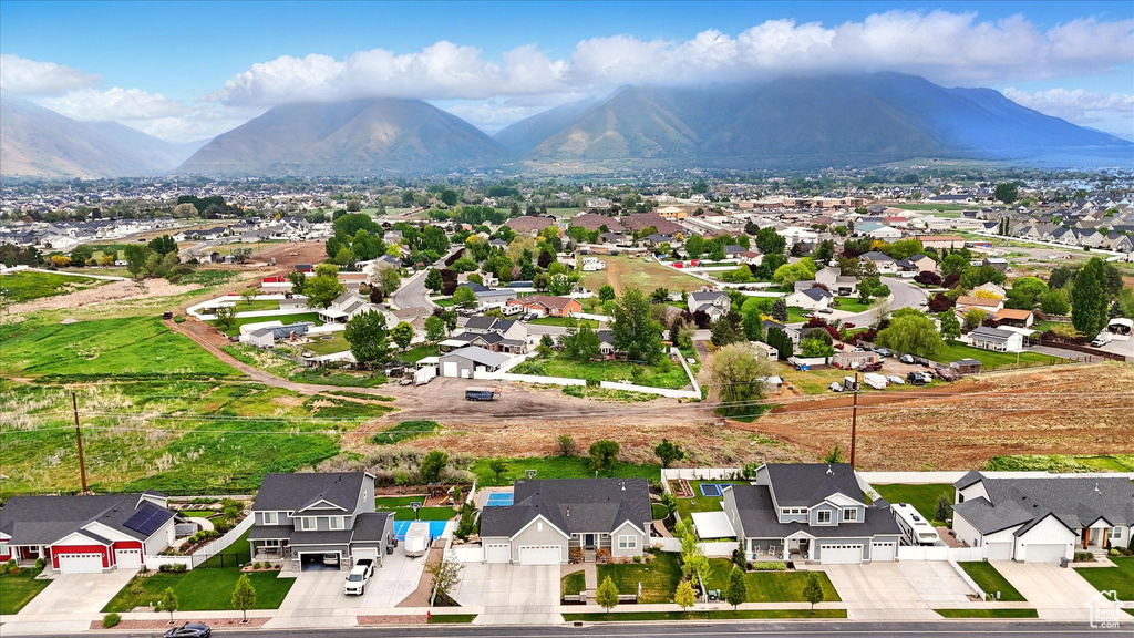 Birds eye view of property with a mountain view and a residential view
