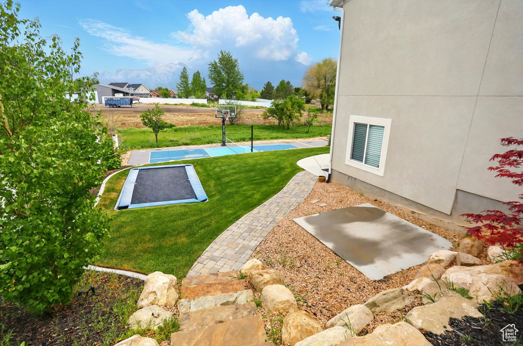 View of yard with basketball hoop