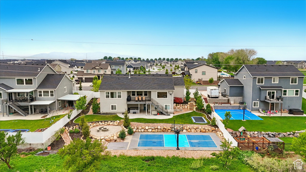 Rear view of house with stairs, a residential view, a fenced backyard, a fenced in pool, and an outdoor fire pit