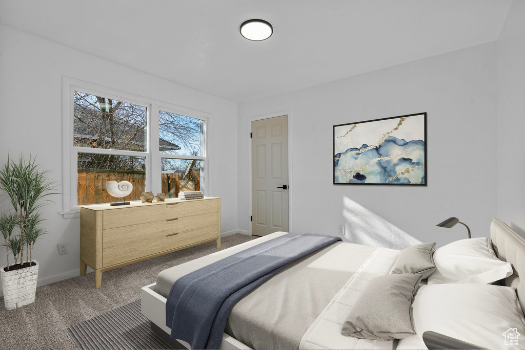 Bedroom featuring carpet floors and baseboards