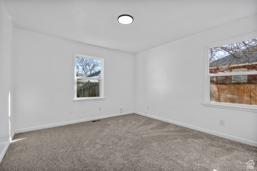 Unfurnished room with carpet