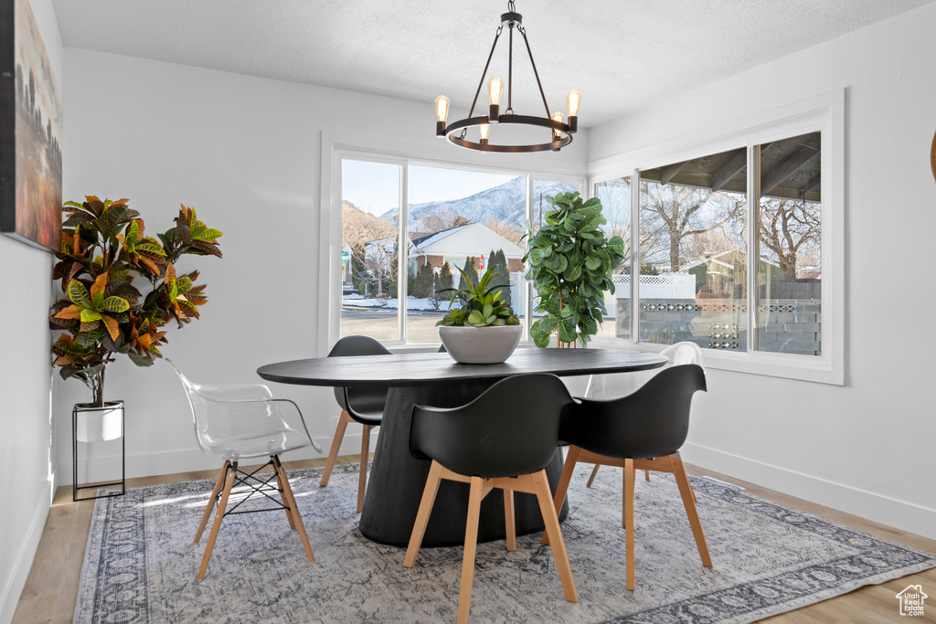 Dining area featuring a mountain view, light wood-type flooring, and a chandelier