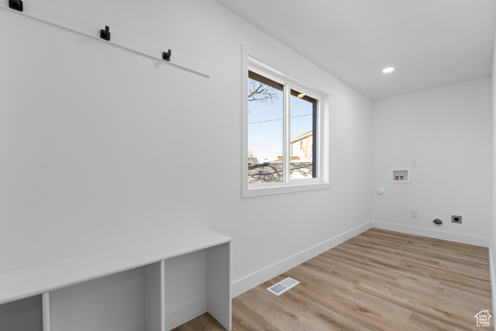 Laundry room with washer hookup, hookup for a gas dryer, light hardwood / wood-style flooring, and electric dryer hookup