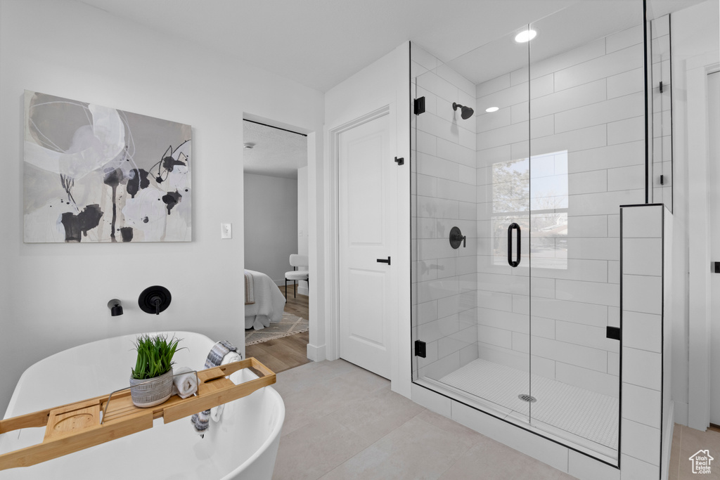 Bathroom with tile patterned floors and plus walk in shower