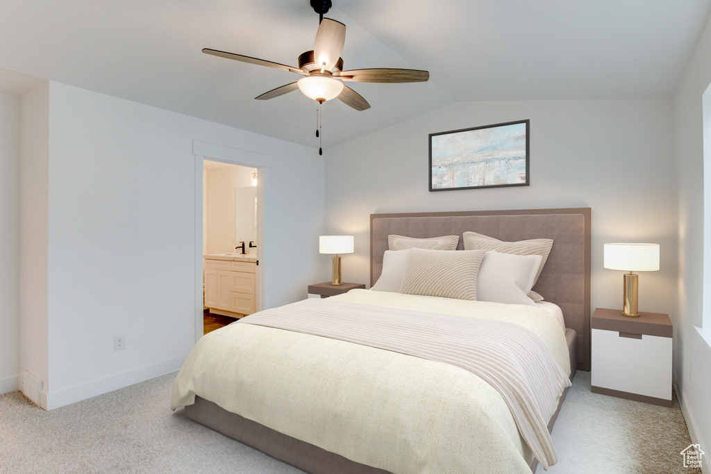 Bedroom with ceiling fan, ensuite bath, vaulted ceiling, and light colored carpet