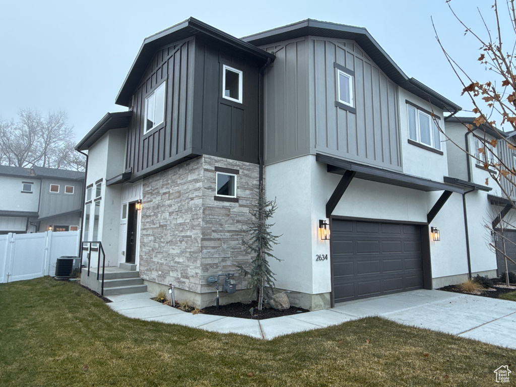 Exterior space featuring central AC, a garage, and a yard