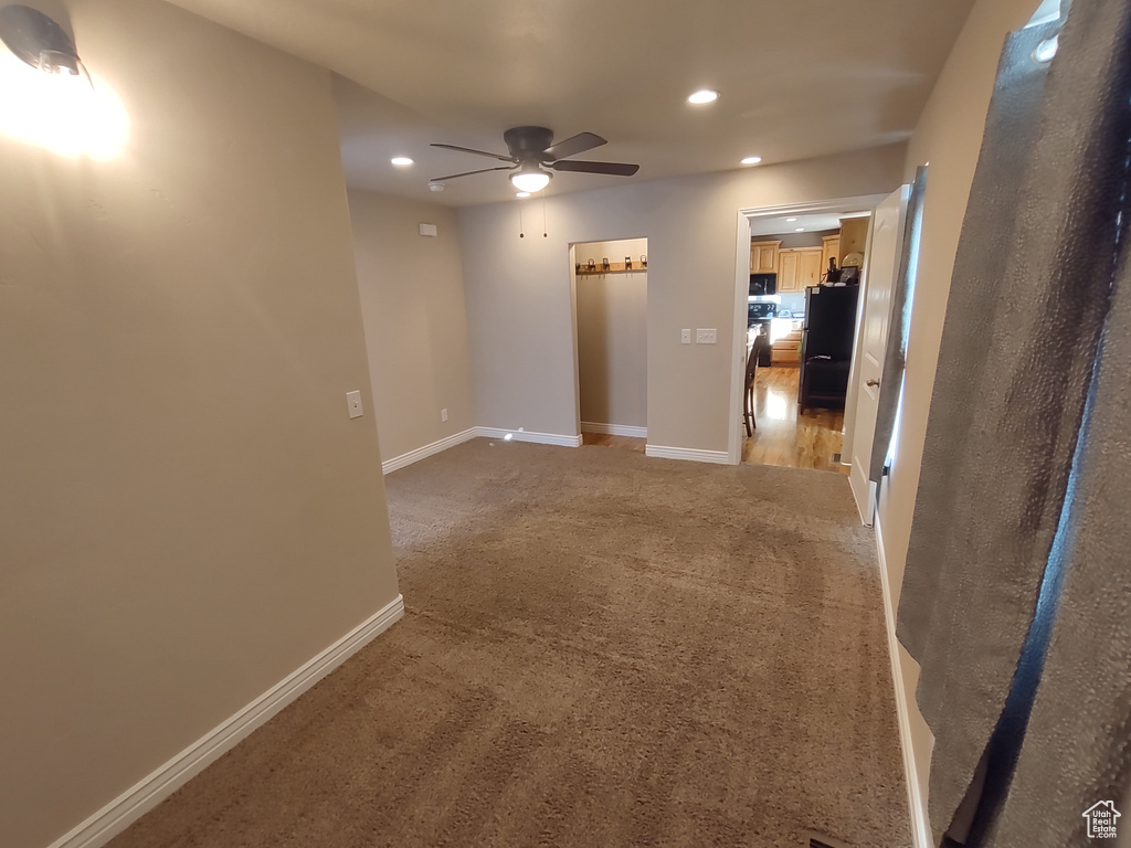 Spare room featuring recessed lighting, baseboards, light carpet, and ceiling fan
