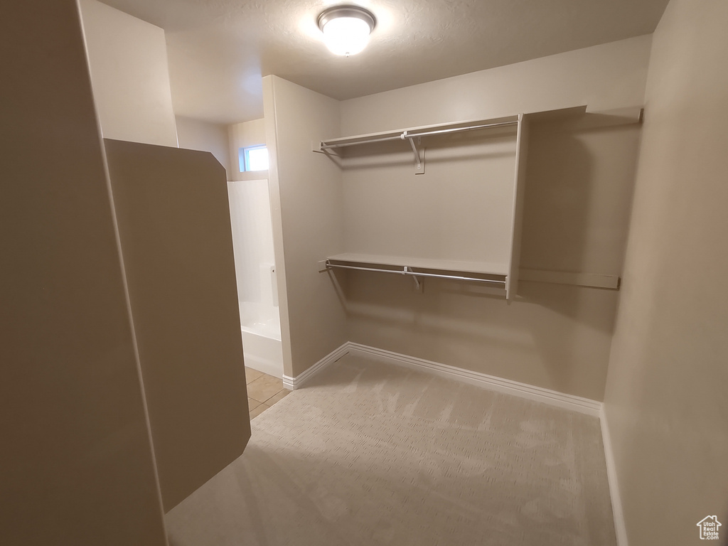 Walk in closet featuring tile patterned flooring