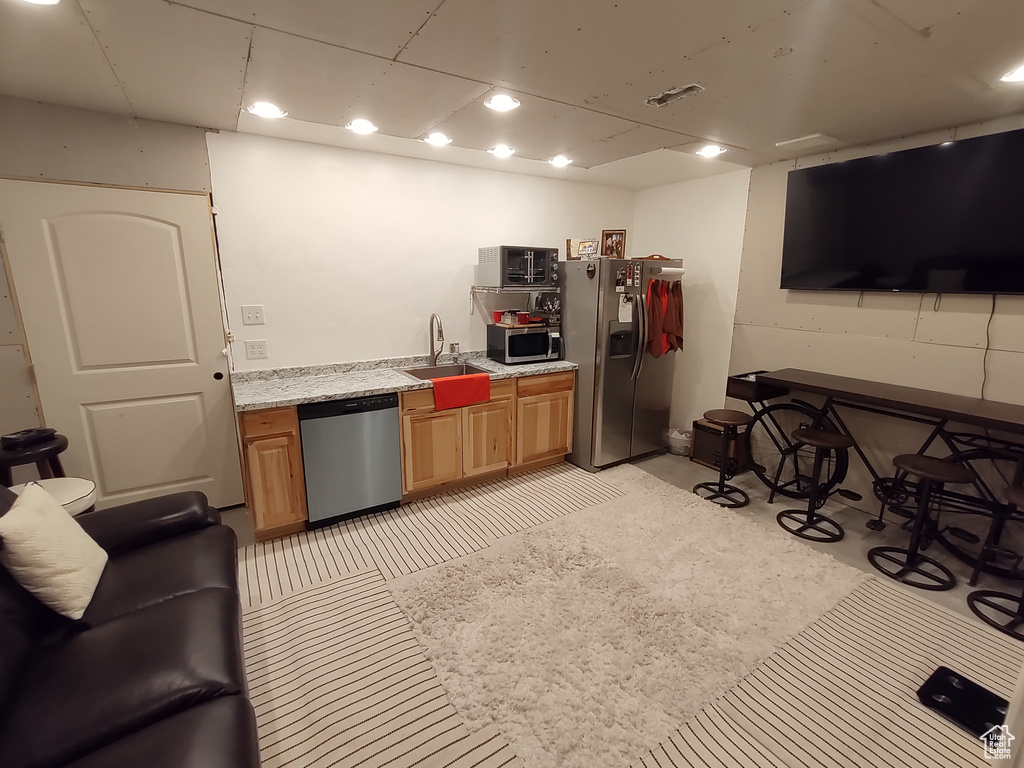 Kitchen with a sink, light countertops, visible vents, and stainless steel appliances