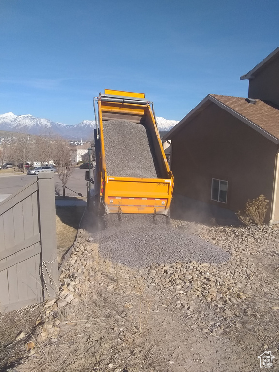 View of side of home with a mountain view and washer / clothes dryer