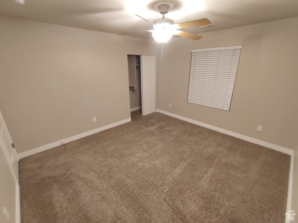 Unfurnished bedroom with a closet, ceiling fan, baseboards, and carpet