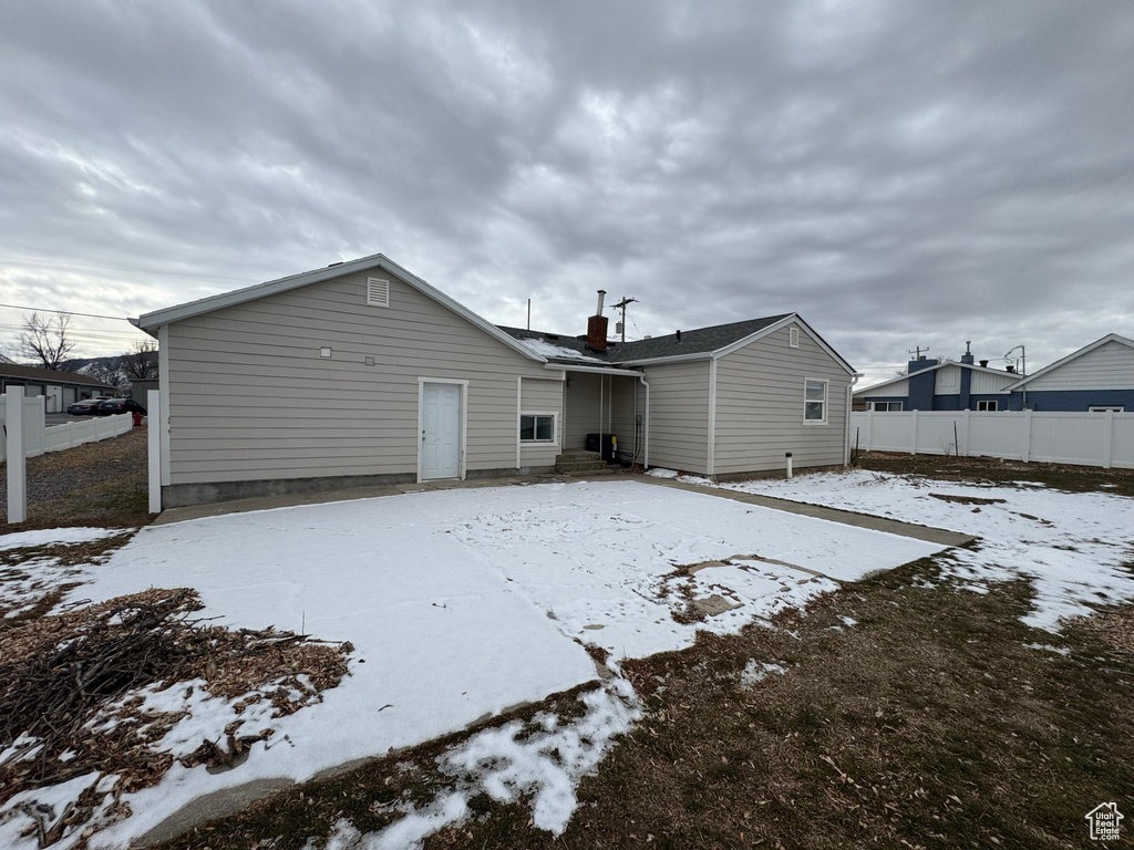 View of snow covered rear of property