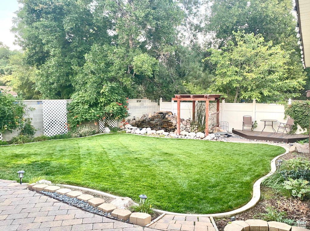 View of yard with a wooden deck