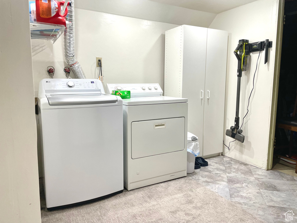 Laundry area featuring cabinets and washing machine and clothes dryer