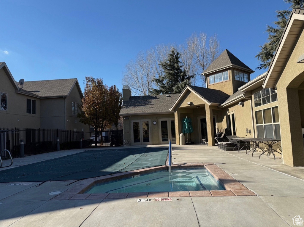 View of swimming pool featuring an in ground hot tub and a patio