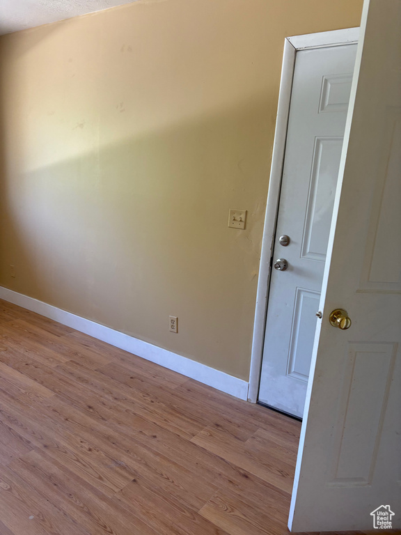 Spare room featuring baseboards and wood finished floors