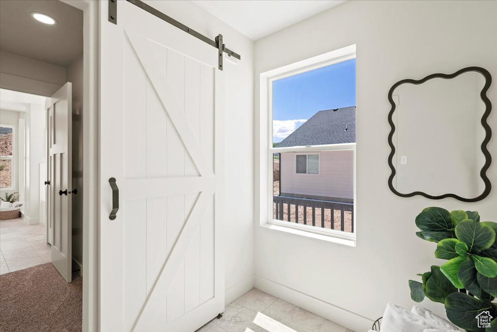 Doorway featuring baseboards and a barn door