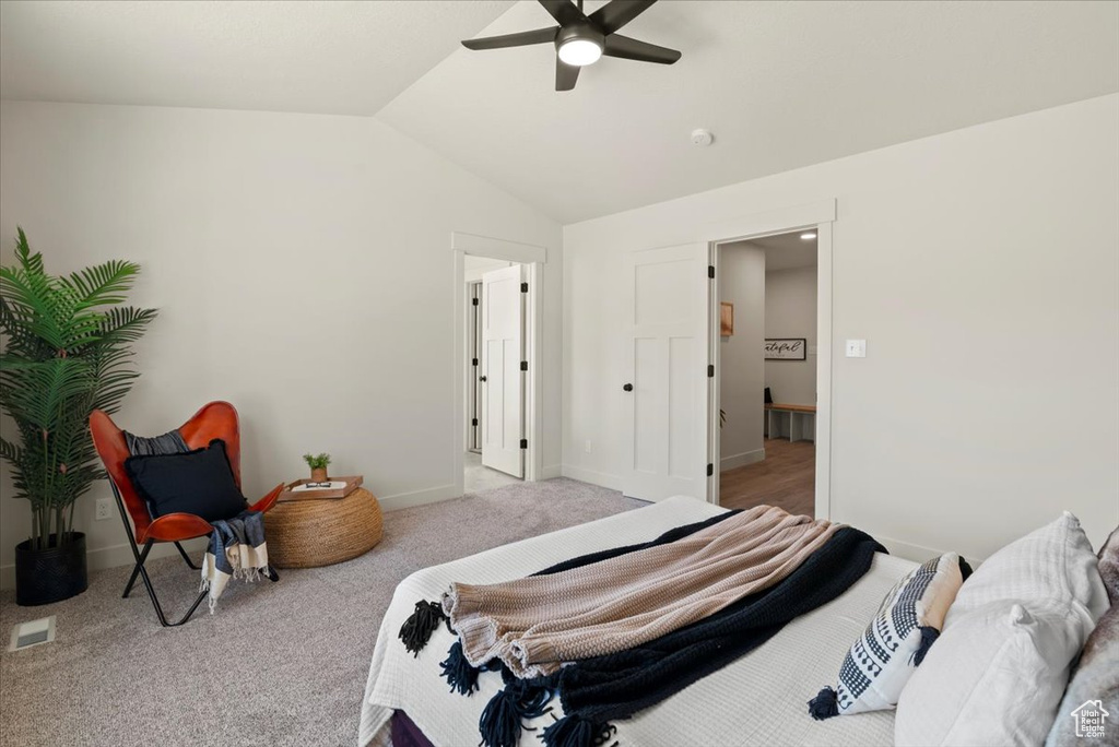 Bedroom with baseboards, ceiling fan, visible vents, vaulted ceiling, and carpet floors