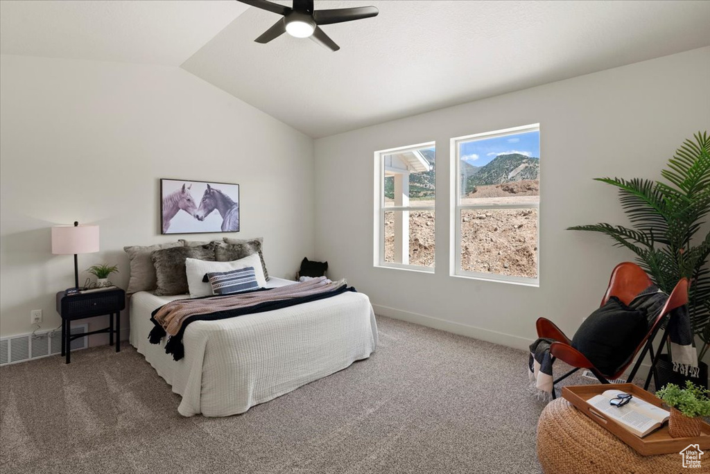 Bedroom featuring carpet flooring, vaulted ceiling, baseboards, and a ceiling fan