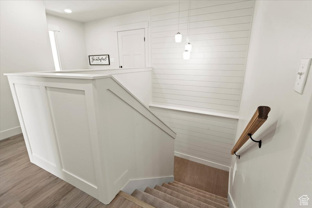 Stairway with baseboards and wood finished floors