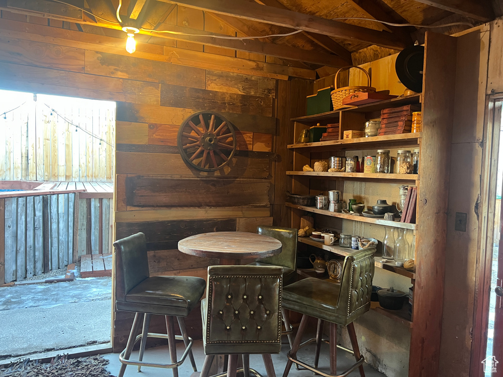 Dining area featuring wooden walls